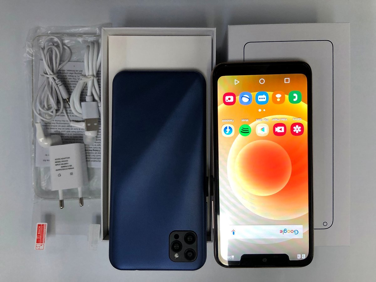 MaxPhone smartphone in blue beside its box, charger and earphones