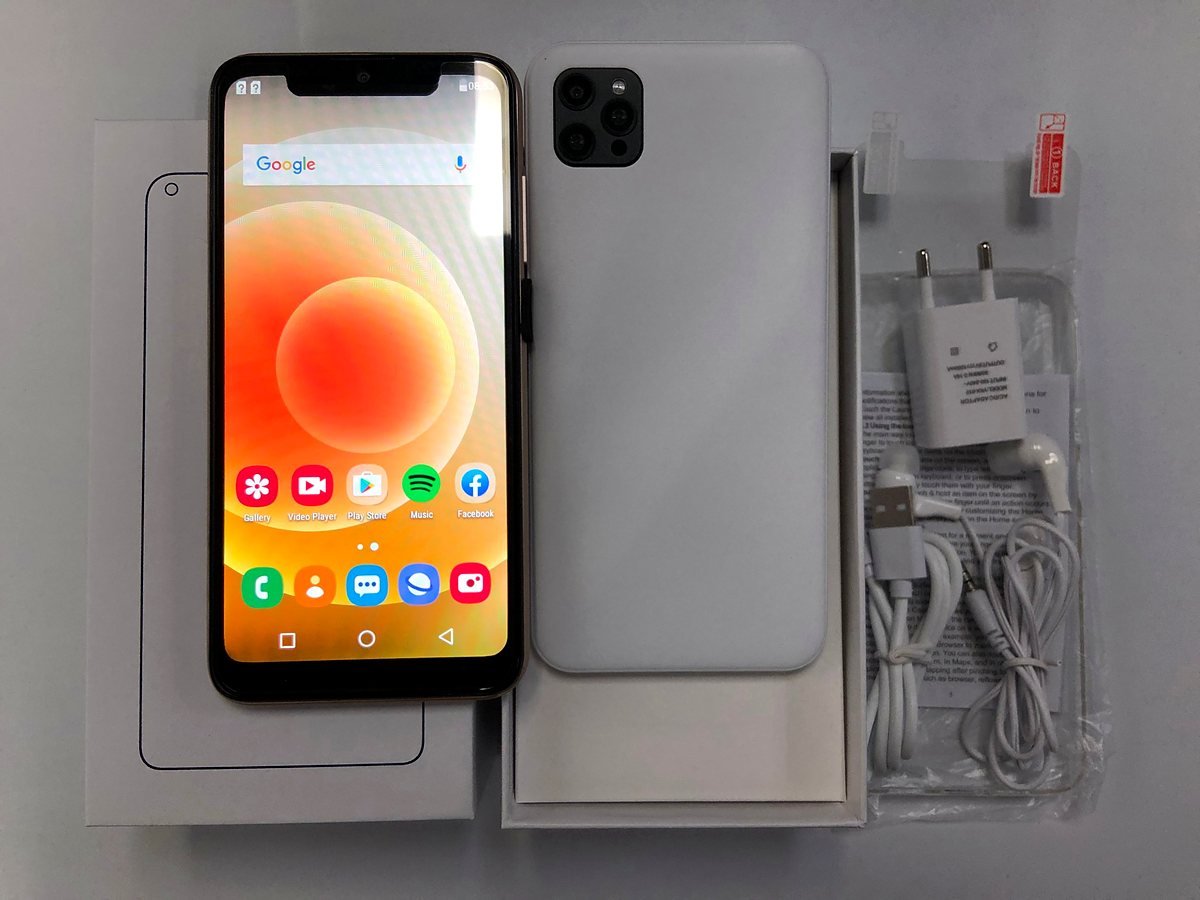 MaxPhone smartphone in white beside its open box and accessories